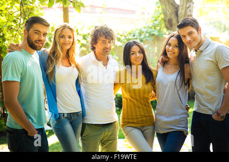 Happy friends standing outdoors Stock Photo