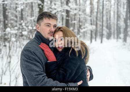 Portrait of happy couple in winter park Stock Photo