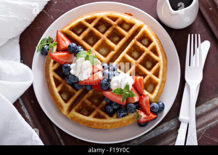 Fresh homemade waffles with ricotta served with whipped cream and berries Stock Photo