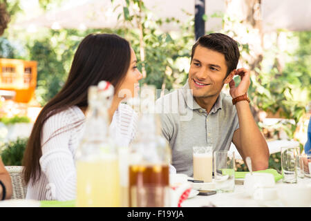 Portrait of a happy couple sitting in outdoor restaurant Stock Photo