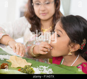 Indian family dining at home. Candid photo of Asian people eating rice with hands. India culture. Stock Photo