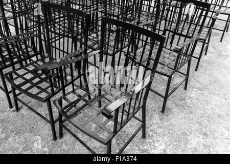 Vintage black metal chairs stand in a row Stock Photo
