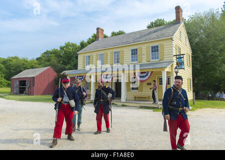 Old Bethpage, New York, USA. 30th Aug, 2015. American Civil War soldiers from the 14th Brooklyn Regiment (14th New York State Militia) AKA The Brooklyn Chasseurs, are portrayed in front of the yellow and white Noon Inn tavern during the Old Time Music Weekend at the Old Bethpage Village Restoration. During their historical reenactments, members of the non-profit 14th Brooklyn Company E wear accurate reproductions of ''The ''Red Legged Devils'' original Union army uniform. Credit:  Ann Parry/ZUMA Wire/Alamy Live News Stock Photo
