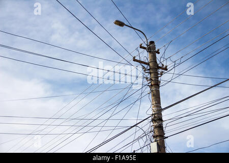 Lamp post with many cables that run in different directions Stock Photo