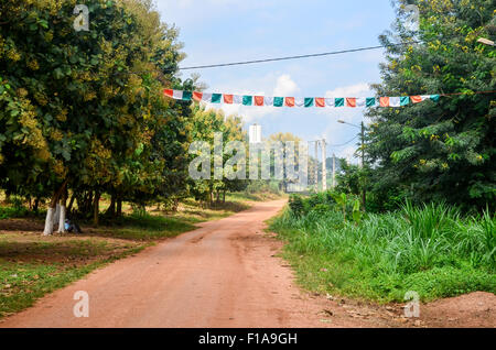 Ivorian flags in rural Ivory Coast on a dirt road Stock Photo