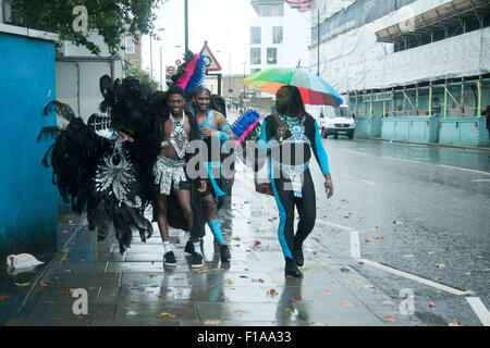 Notting Hill London,UK. 31st August 2015.  Performers sheltering from the rain at  the Notting Hill Carnival,Europe's biggest street festival on August bank holiday Credit:  amer ghazzal/Alamy Live News Stock Photo