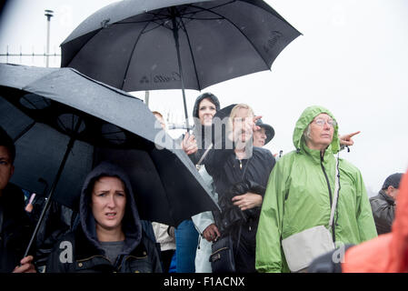 Southend-on-Sea, UK. 31st Aug, 2015. Spectators stand in the rain at Southend Pierhead to watch the start of the 2015/16 Clipper Round the World Race Credit:  Terence Mendoza/Alamy Live News Stock Photo