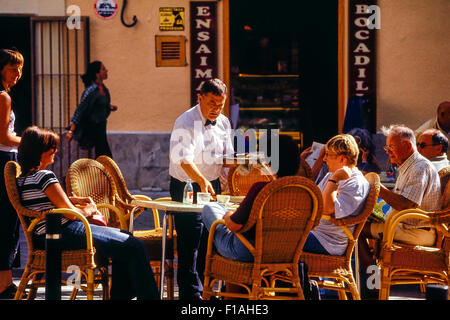 Waitor serving at a street cafe. Palma. Majorca. Balearic Islands. Spain Stock Photo