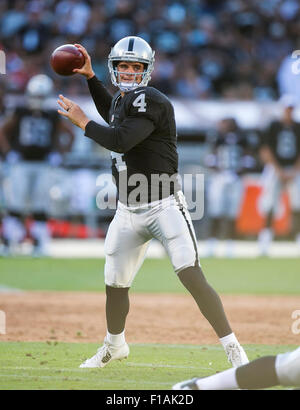 Oakland, CA. 30th Aug, 2015. Oakland Raiders quarterback Derek Carr (4) in action during the NFL football game between the Oakland Raiders and the Arizona Cardinals at the O.co Coliseum in Oakland, CA. The Cardinals defeated the Raiders 30-23. Damon Tarver/Cal Sport Media/Alamy Live News Stock Photo