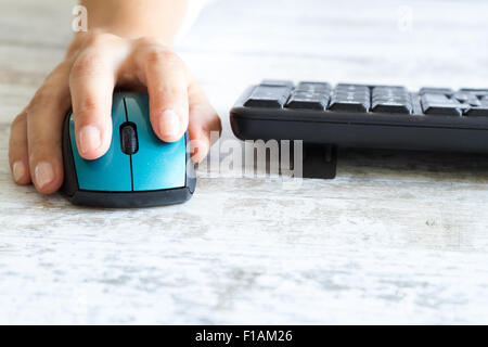 Using the computer, clicking the mouse and typing in the keyboard Stock Photo