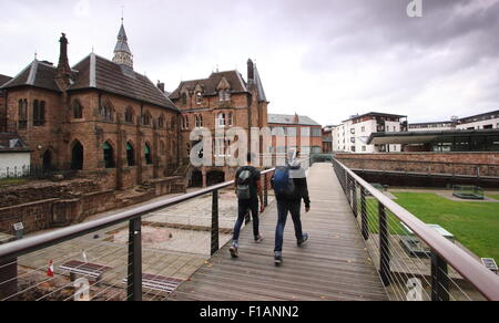 Two males approach the Priory Visitor Centre, home to the ruins of the Coventry's first cathedral, Coventry England UK Stock Photo