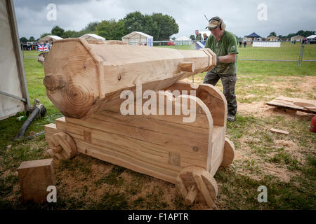 Cheshire, UK. 31st Aug, 2015. Mick Burns puts the finishing touches to his cannon at The 11th English Open Chainsaw Carving Competition held at the Cheshire Game and Country Show at the Cheshire County Showground Credit:  John Hopkins/Alamy Live News Stock Photo
