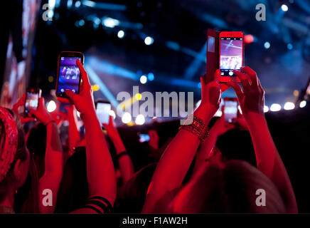 Hands holding up cell phones at a music concert Stock Photo