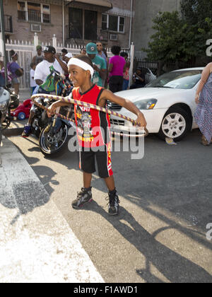 Boy plays with hoola hoop at Spike Lee block party in the Bedford Stuyvesant section of Brooklyn, New York, Aug. 29, 20015. Stock Photo