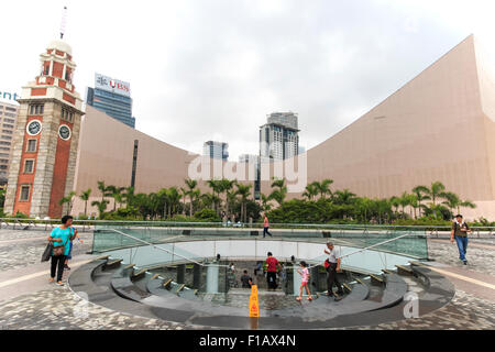 Kowloon, Hong Kong - August 14,2015: People walking near the Clock Tower, on the southern shore of Tsim Sha Tsui. This is the lo Stock Photo