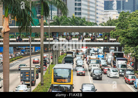 Kowloon, Hong Kong - August 14,2015: Detail of a street in central Hong Kong with heavy traffic and palm trees in the center of Stock Photo