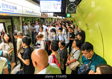 Kowloon, Hong Kong - August 14,2015: Commuters waiting for a train in the MTR Wan Chai in Hong Kong Stock Photo