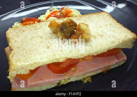 Ham and tomato sandwich with scrambled egg Stock Photo