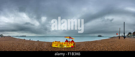 Lifeguards on the beach at Brighton on a miserable day in August. Stock Photo