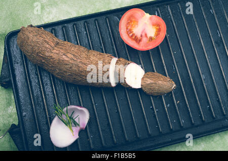 Sweet potato, tomato, onion and rosemary on grill Stock Photo