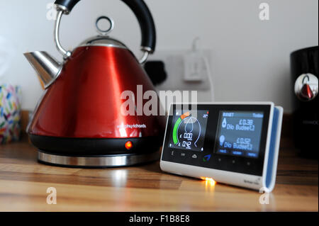 British Gas smart meter showing consumption of electricity and gas used with domestic appliance a kettle in the kitchen Stock Photo