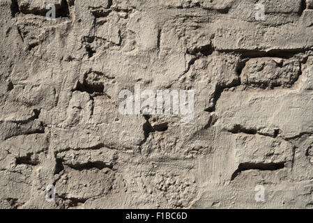Gnarled old surface of plastered wall as background.  Bruges Stock Photo