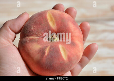 Paraguayo or Flat Peach, also known as Saturn Peach, Chinese Flat Peach,  Doughnut Peach, Donut Peach. Stock Photo