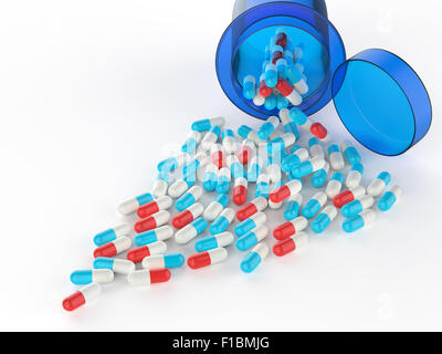 Pills spilling out of pill bottle on white Stock Photo