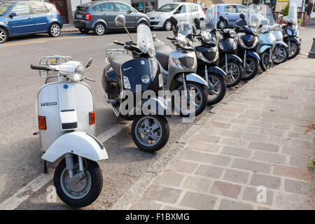 Lacco Ameno, Italy - August 15, 2015: Classic Vespa and Honda scooters stands parked on a roadside, Ischia island Stock Photo