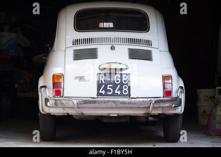 Casamicciola Terme, Italy - August 19, 2015: Old white fiat 500 L car stands in dark garage, rear view Stock Photo