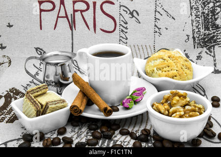 Coffee still life with coffee, coffee beans, cinnamon and desserts. Stock Photo