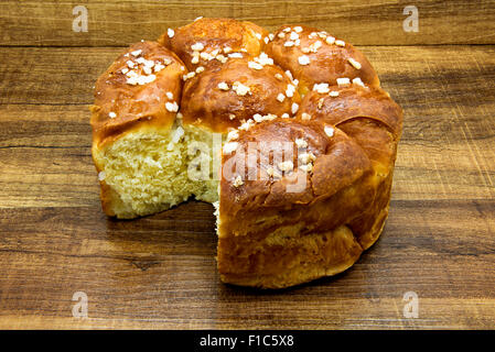 White bread with slices of sugar on wooden table. Stock Photo
