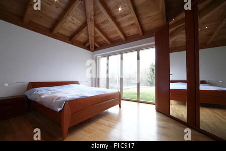 Modern loft apartment furnished, bedroom Stock Photo