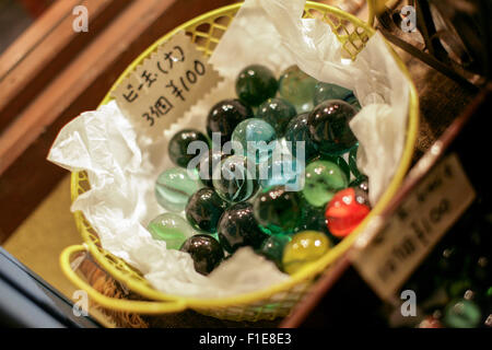 Assorted marbles yellow basket Stock Photo