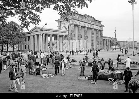 Tourists buying souvenirs in front of the Brandenburg gate, Berlin, 1 day before the reunification of East and West Germany, Stock Photo