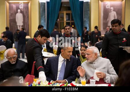 U.S. President Barack Obama listens to Indian Prime Minister Narendra Modi during the State Dinner at Rashtrapati Bhawan January 25, 2015 in New Delhi, India. Stock Photo