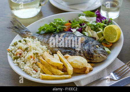 Bream with potato, rice and salad, Greek food Stock Photo