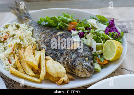 Sea bream with potato, rice and salad, top view Stock Photo