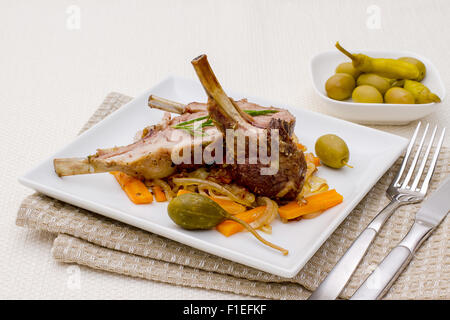 Grilled racks of lamb with olive, capers and carrot Stock Photo