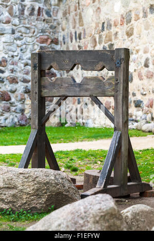 Wooden medieval torture device, ancient pillory. Stock Photo