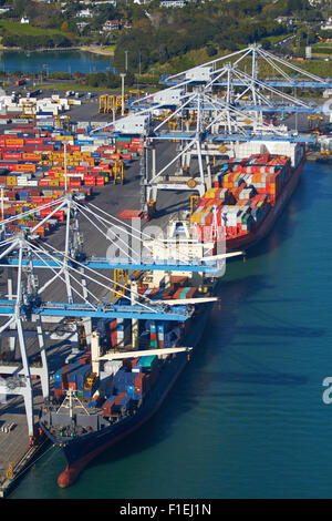 Ships and containers at Ports of Auckland, Auckland, North Island, New Zealand - aerial Stock Photo