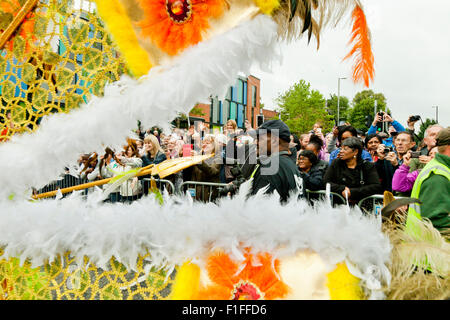 Leeds, UK. 31st Aug, 2015. Crowds framed by the Leeds West Indian Carnival Parade Queens costume lined along Chapeltown Road, Leeds, West Yorkshire, UK Credit:  Graham Hardy/Alamy Live News Stock Photo