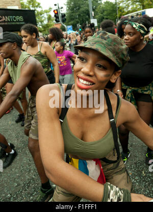 Leeds, UK. 31st Aug, 2015. A young woman dressed in military themed costumes dances along Harehills Avenue during the Leeds West Indian Carnival Parade, West Yorkshire, UK Credit:  Graham Hardy/Alamy Live News Stock Photo