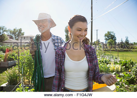 Smiling father and daughter in sunny garden