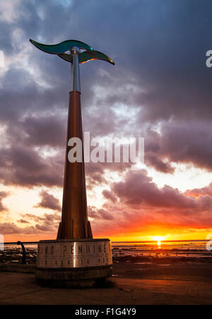 Rotating tall spinning weathervane Southport, Seafront & Promenade attractions. Colourful sunset over the Irish Sea on the north west coast of Sefton.  UK Weather wind vane, wind speed and direction instrument;   This device is a TPT Seamark on Southport’s Promenade, a  tall towering outdoor weather station wind spinner, which serves as a marker for the start of the east-west trail of The Trans Pennine coast-to-coast trail. Stock Photo