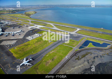 Emirates Airbus A380 and runways at Auckland Airport, North Island, New Zealand - aerial Stock Photo