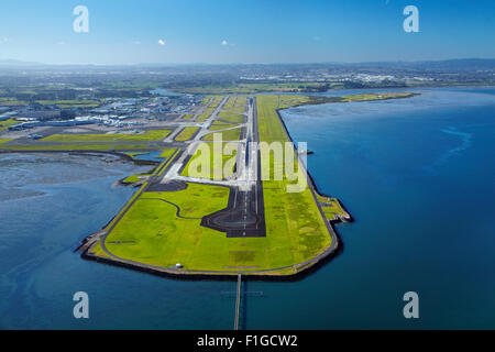 Runway at Auckland Airport, and Manukau Harbour, North Island, New Zealand - aerial Stock Photo