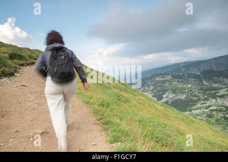 Senior woman walking in the mountain. Stock Photo