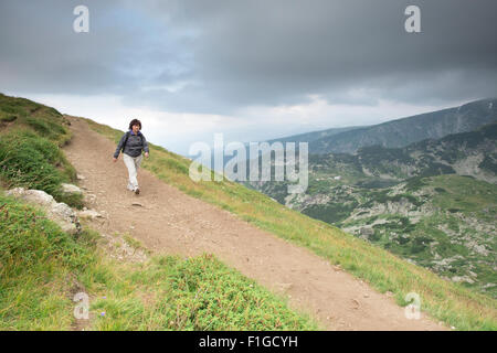 Senior woman walking in the mountain. Stock Photo