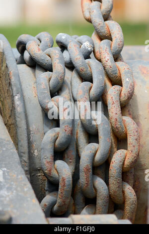 Metal chain on crane used to help lift heavy objects via pulley and gearing system Stock Photo